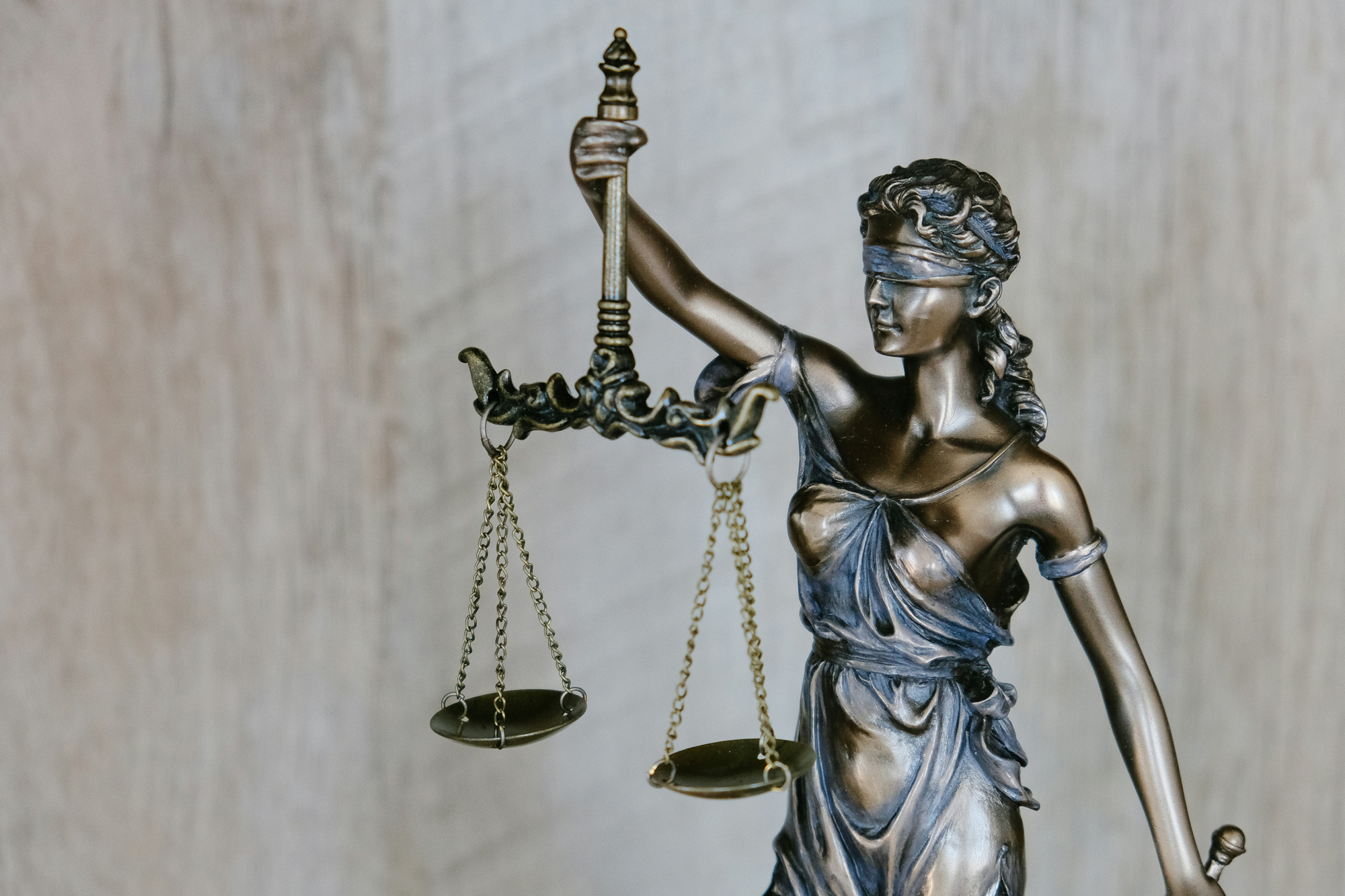 Bronze statue of Lady Justice holding the scales of justice