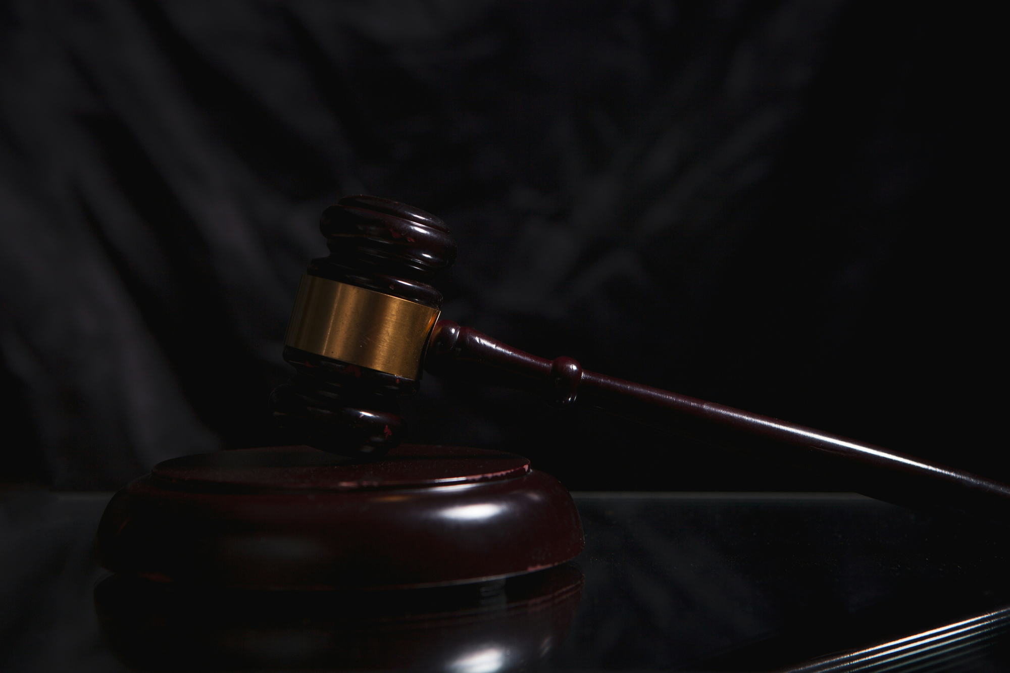 Judge's gavel resting on a sound block